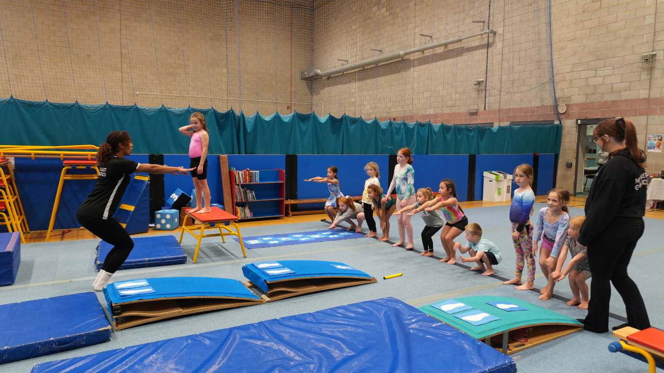 a recreational gymnasts class with gymnasts of various ages overseen by 2 north east gymnastics academy coaches