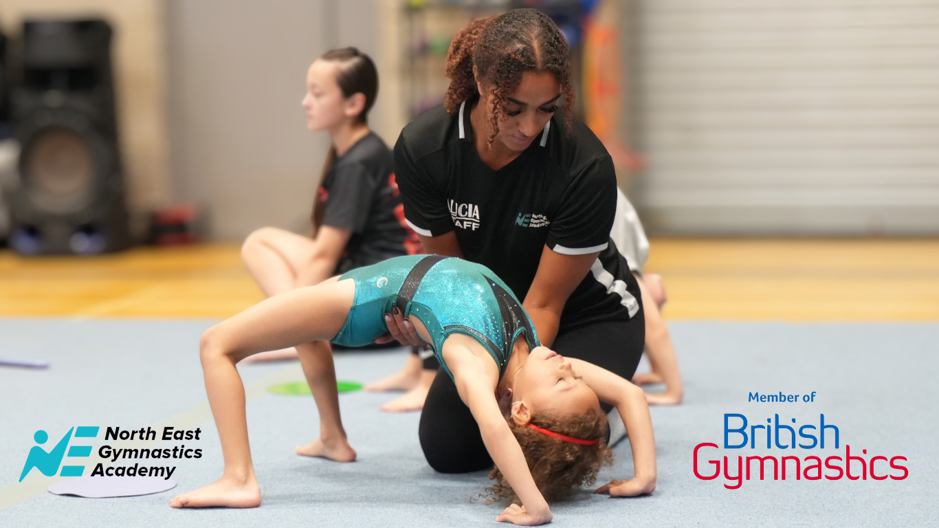 young gymnast doing a bridge with a north east gymnastics academy coach supporting them