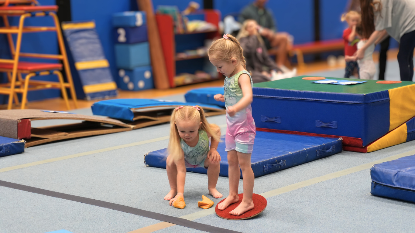 two pre-school gymnasts learning balance and coordination