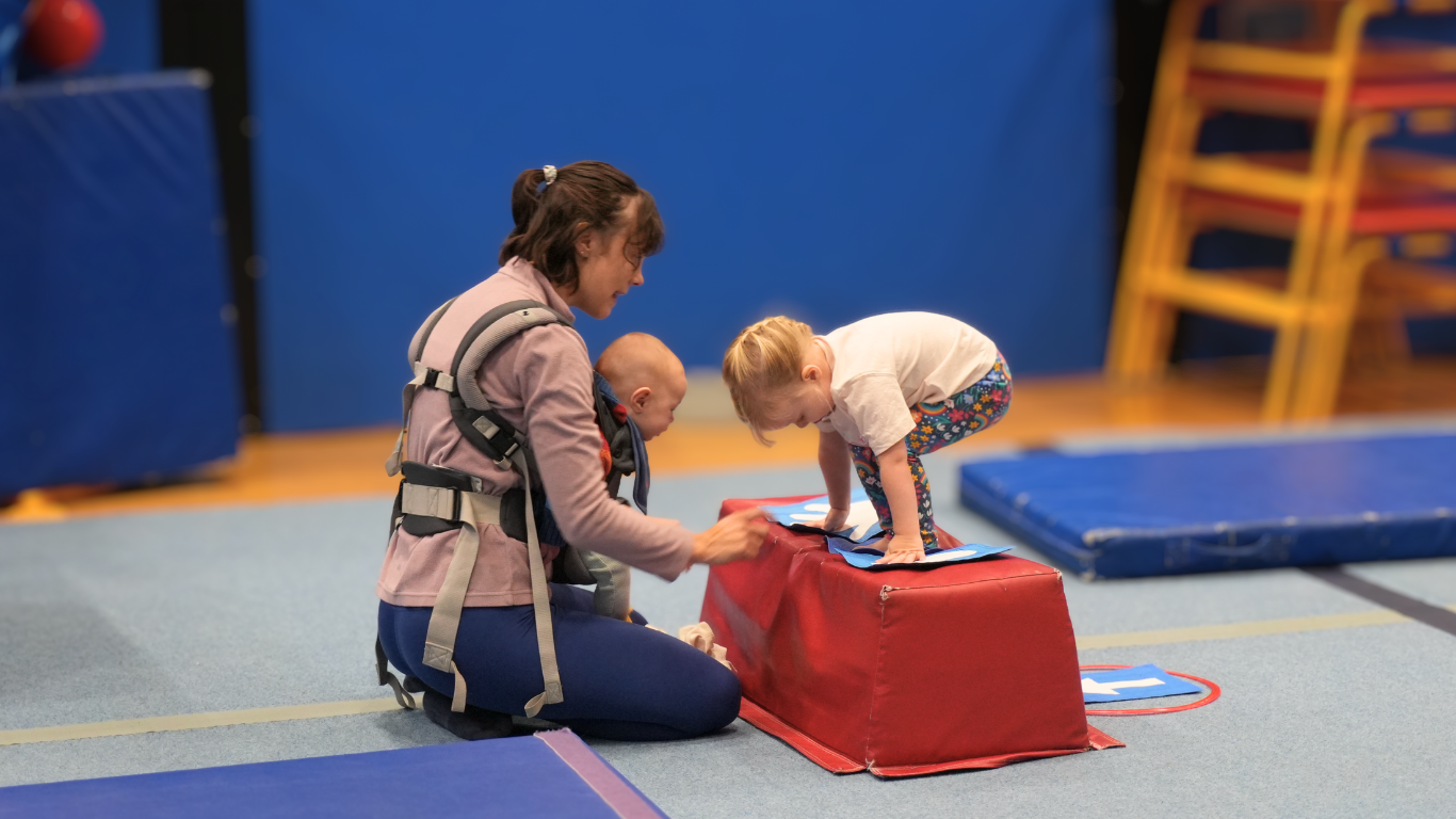 mother with 2 young children at stay and play class
