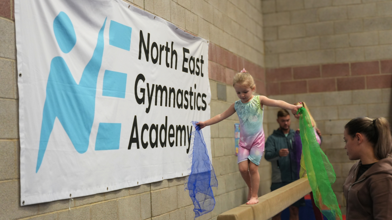 young gymnasts walking along the beam
