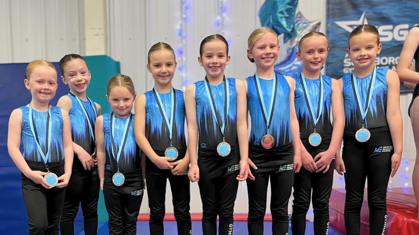 development gymnasts with medals at a competition